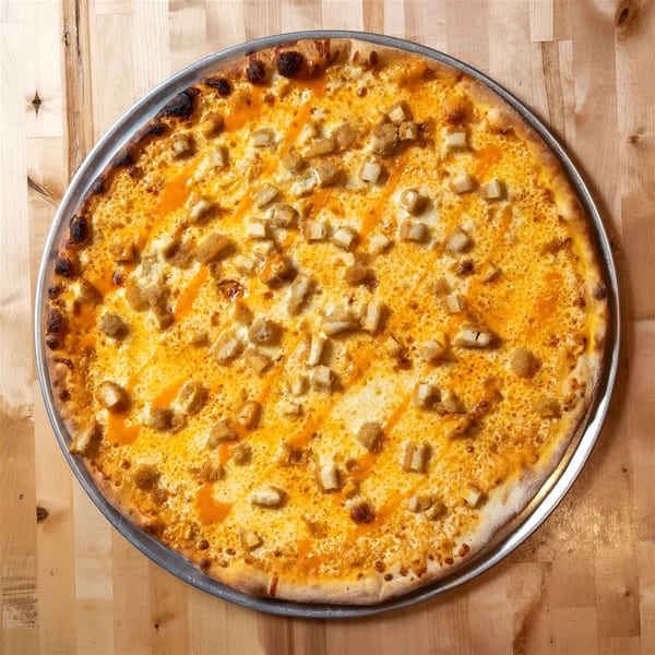 A Buffalo chicken pizza from The NY Pizza Place, with white cheese, orange sauce, and chicken pieces.